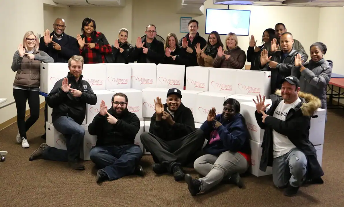 Group of diverse people celebrating with boxes at MFD Staging.